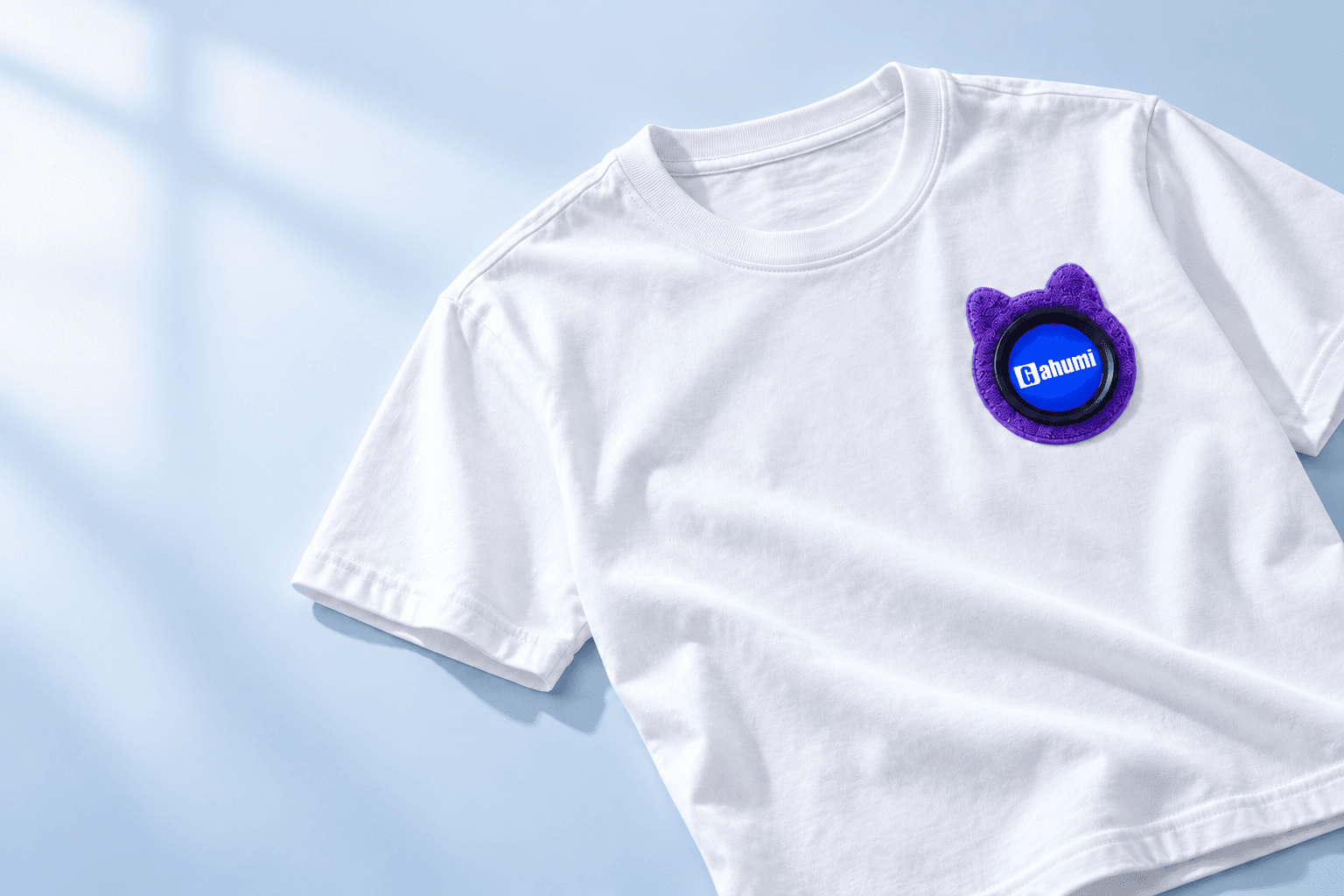 White heavyweight cotton T-shirt with purple towel embroidery and a round display surrounded by black rubber